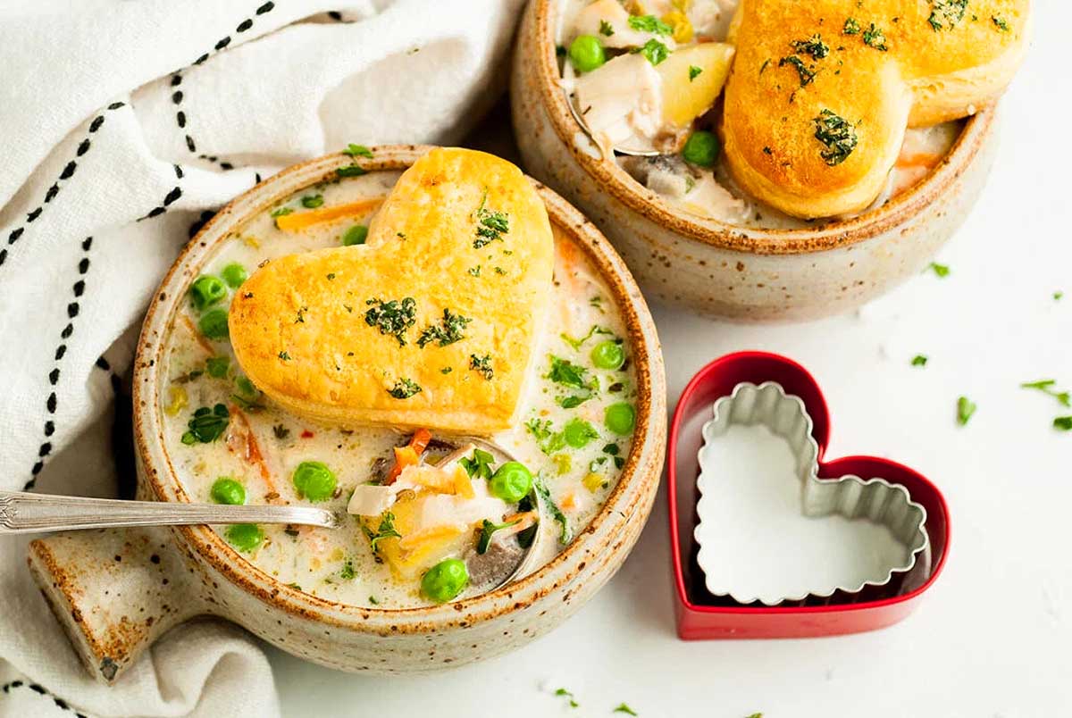 Two bowls of soup with heart shaped biscuits. This is one of the best rotisserie chicken recipes.