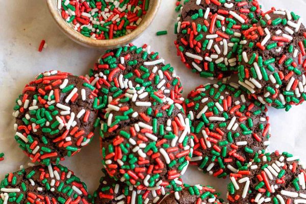 Chocolate sprinkle cookies with red and green sprinkles.
