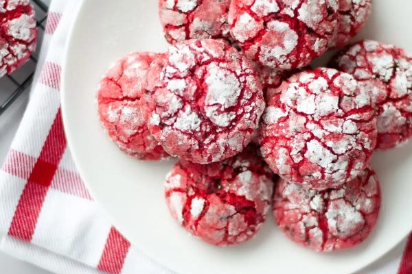 Red crinkle cookies on a white plate.