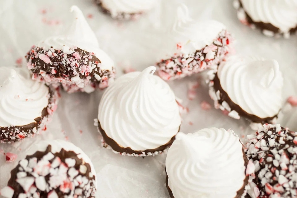 Chocolate peppermint meringue cookies with white icing.