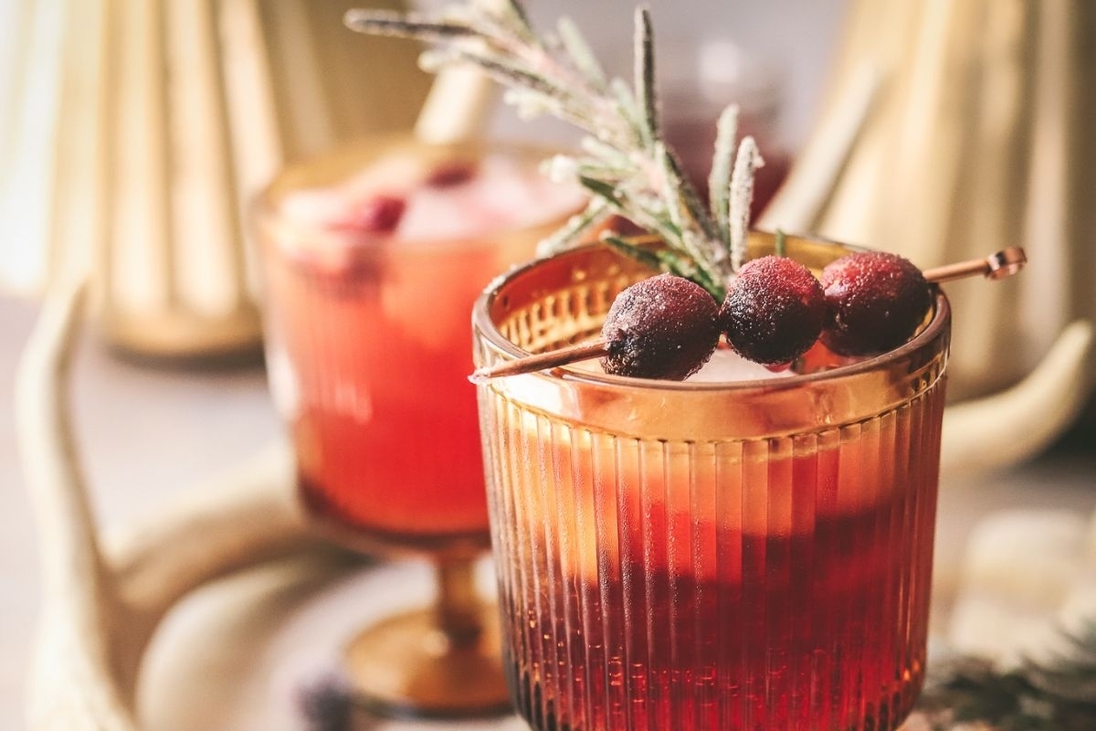 A Thanksgiving-inspired cranberry cocktail garnished with sprigs of rosemary.
