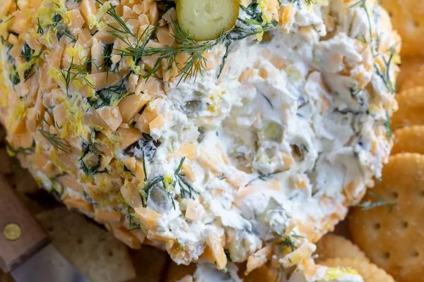 Explore our delicious cheese ball recipe featuring pickles and crackers.