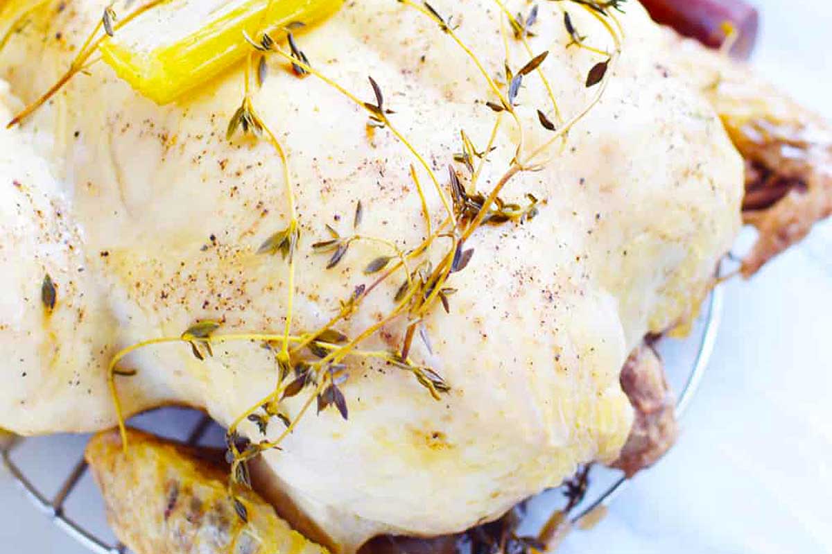 Roasted chicken with thyme and lemons on a wire rack, perfect for Instant Pot Thanksgiving.