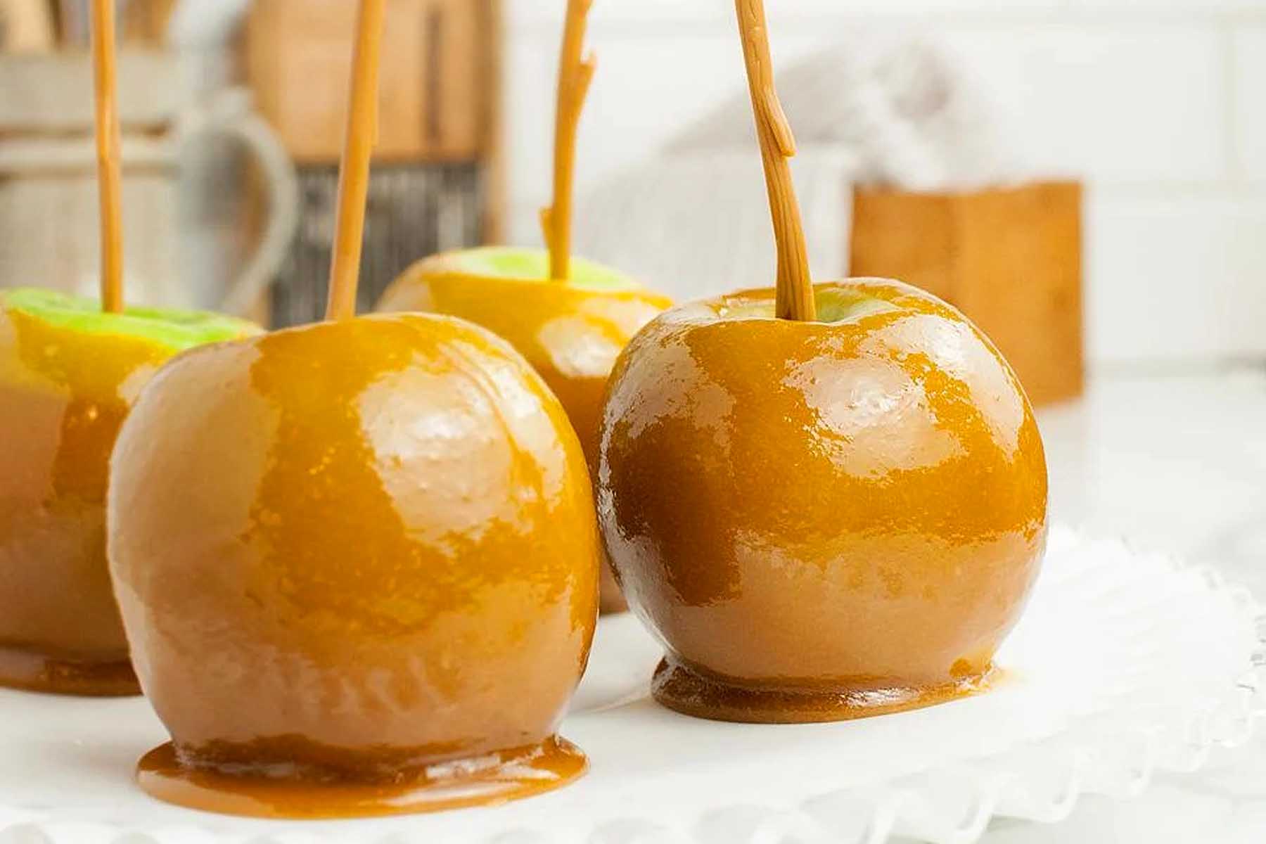 Caramel apples with caramel sauce on a plate. Add this to your list of favorite apple recipes.