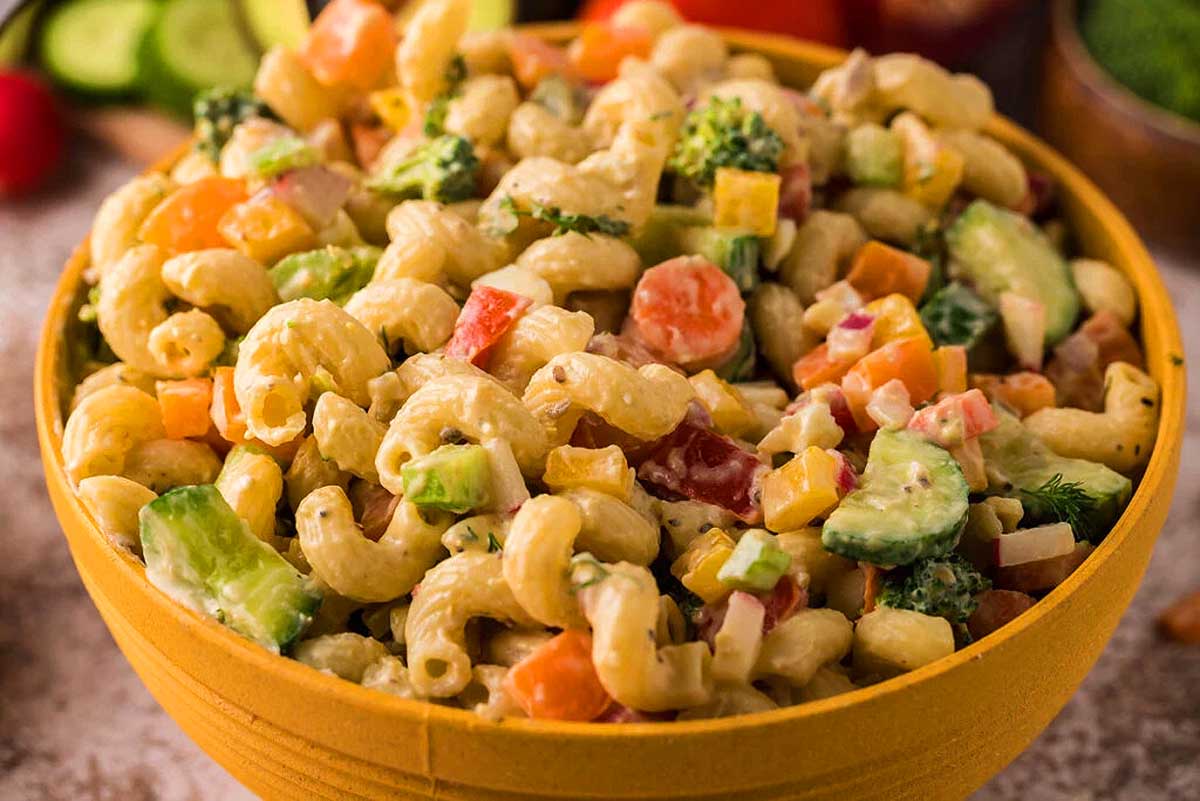 A vibrant Pasta Salad tossed with an assortment of fresh vegetables.