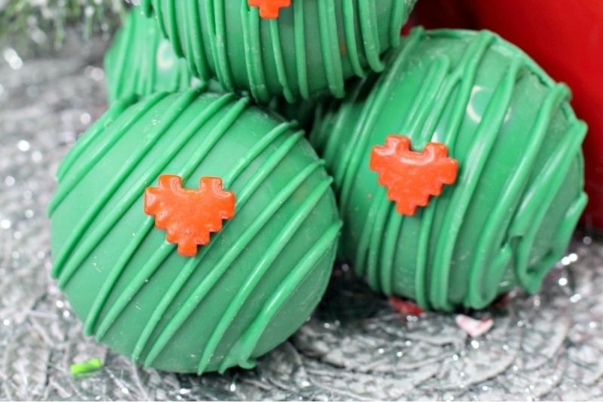 A stack of green Christmas cookies with hearts on them, perfect for spreading holiday cheer.