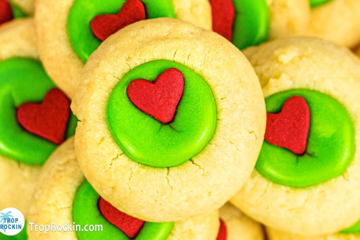 Grinch-inspired cookies decorated with green and red hearts.