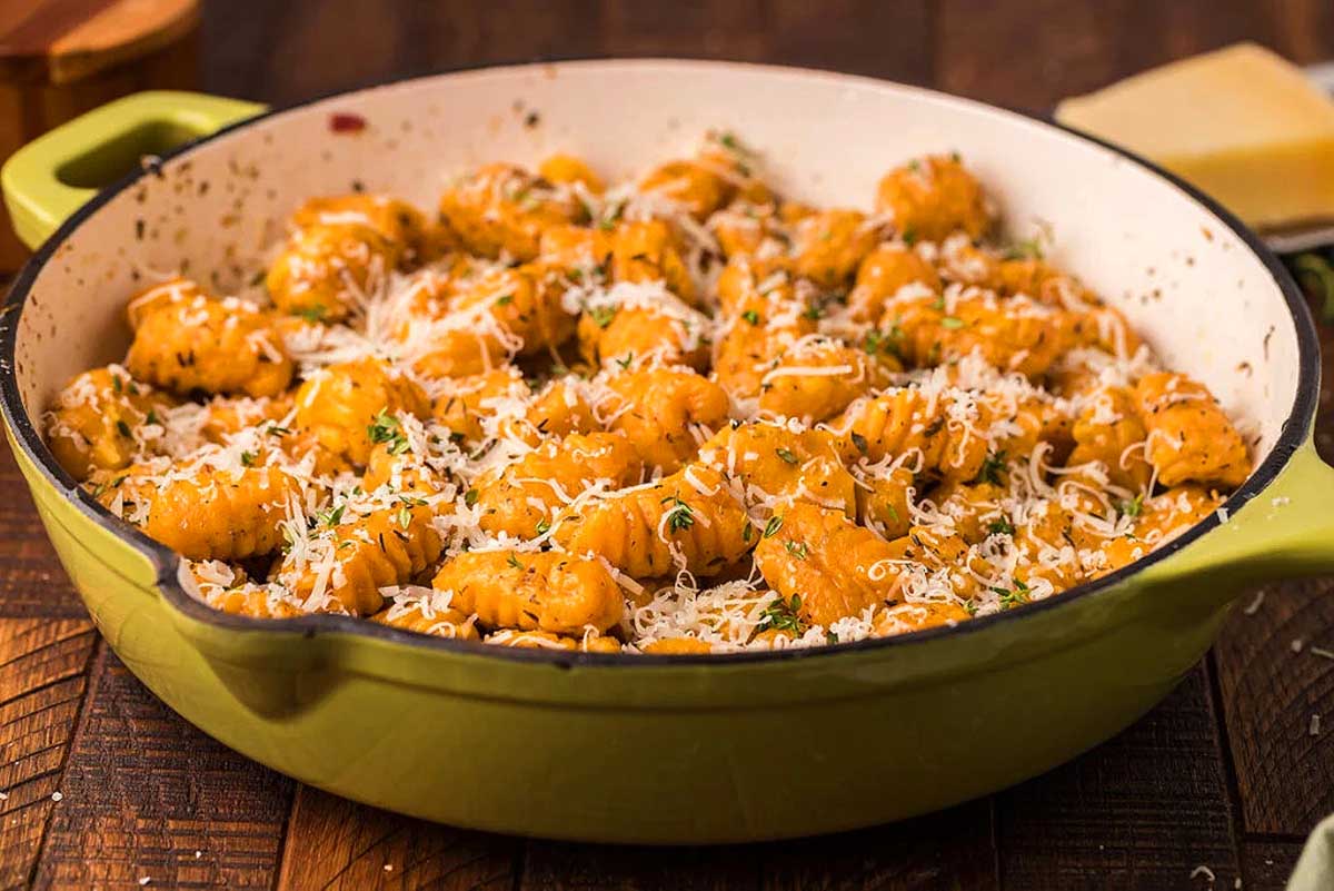 Gnocchi in a green pot with parmesan cheese. This is one of the best gnocchi recipes.