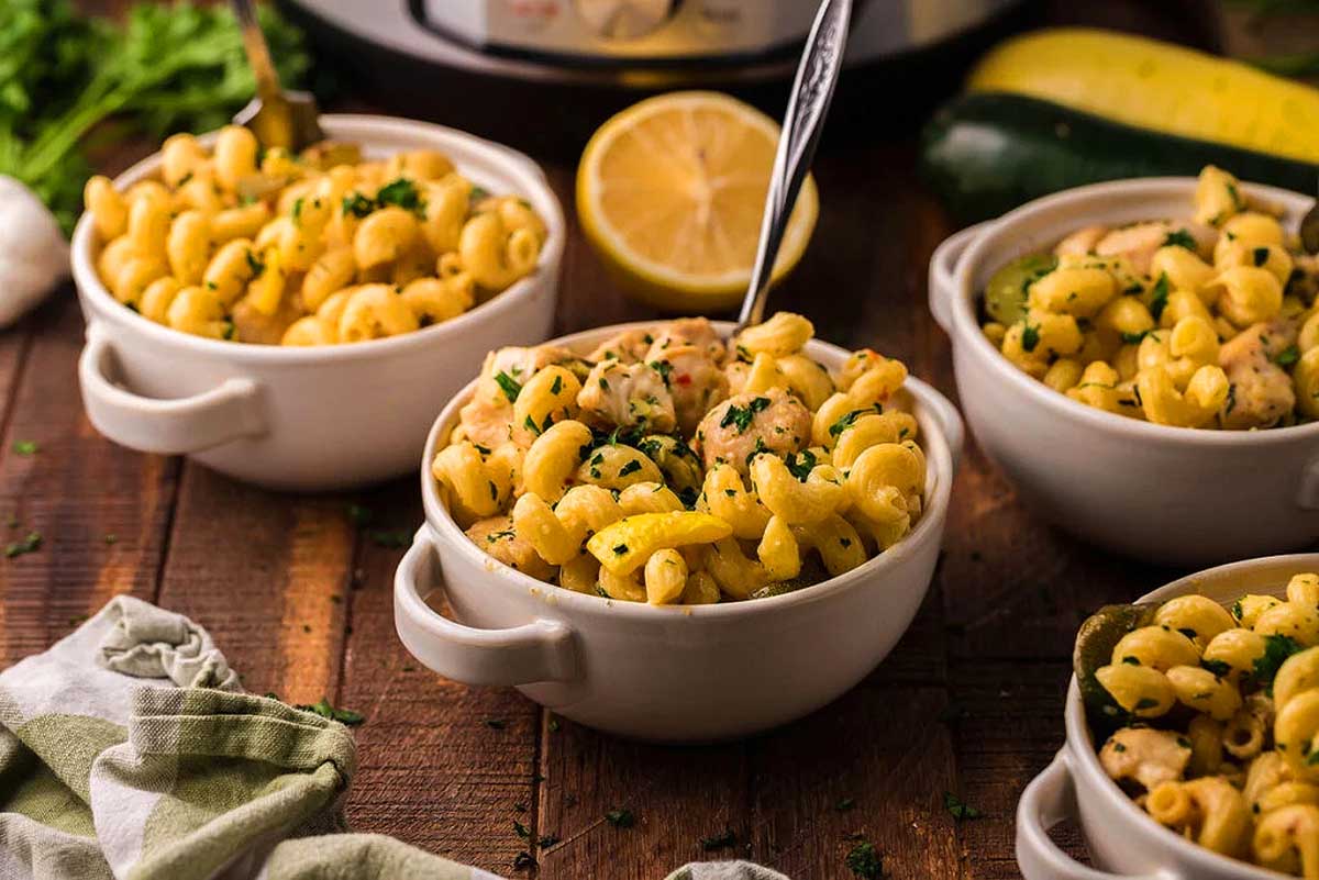Instant pot macaroni and cheese in white bowls on a wooden table.