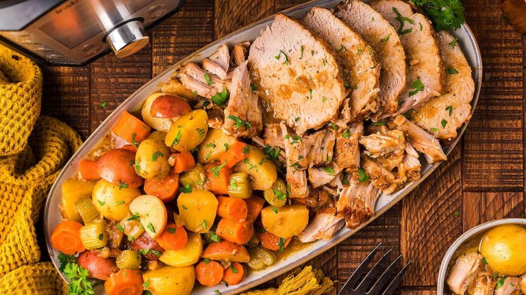 A plate with sliced meat, potatoes and carrots.