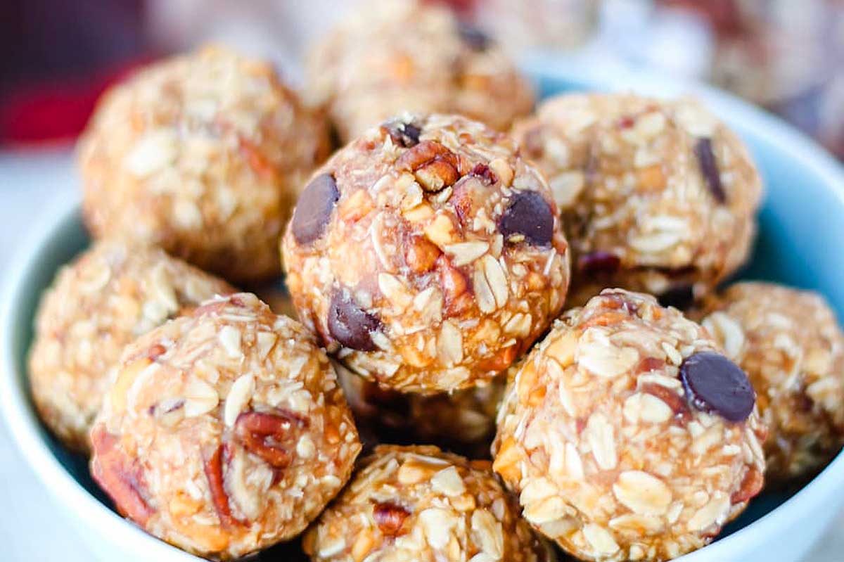 A bowl of pecan-granola energy bites on a table.