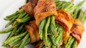 Bacon wrapped green beans on a plate.
