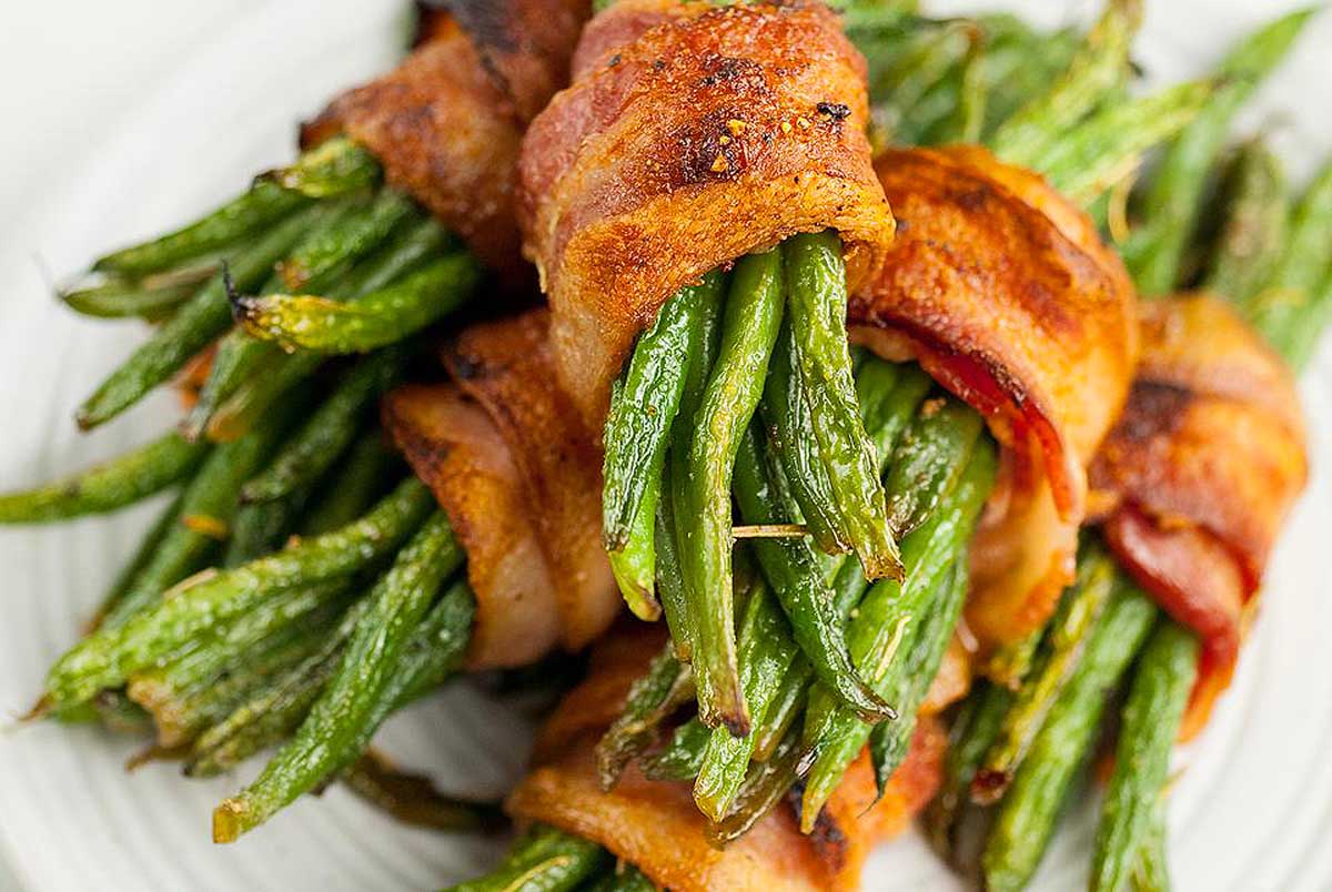 Bacon wrapped green beans on a plate.