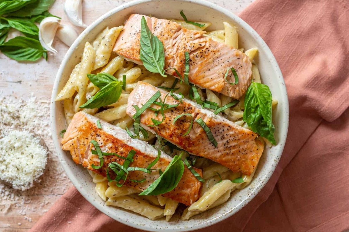 Salmon pasta is a delicious and satisfying dinner option. This dish is made with tender salmon cooked to perfection, tossed together with flavorful basil and topped with grated parmesan cheese to enhance the taste.