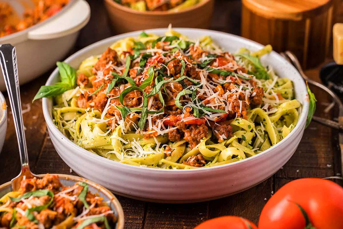 Picky Eater Recipes: A bowl of pasta with meat and tomatoes on a wooden table.