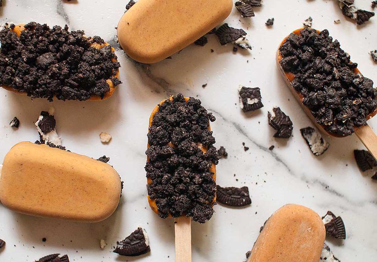 Delicious Oreo popsicles made with an irresistible recipe, displayed on a stunning marble countertop.