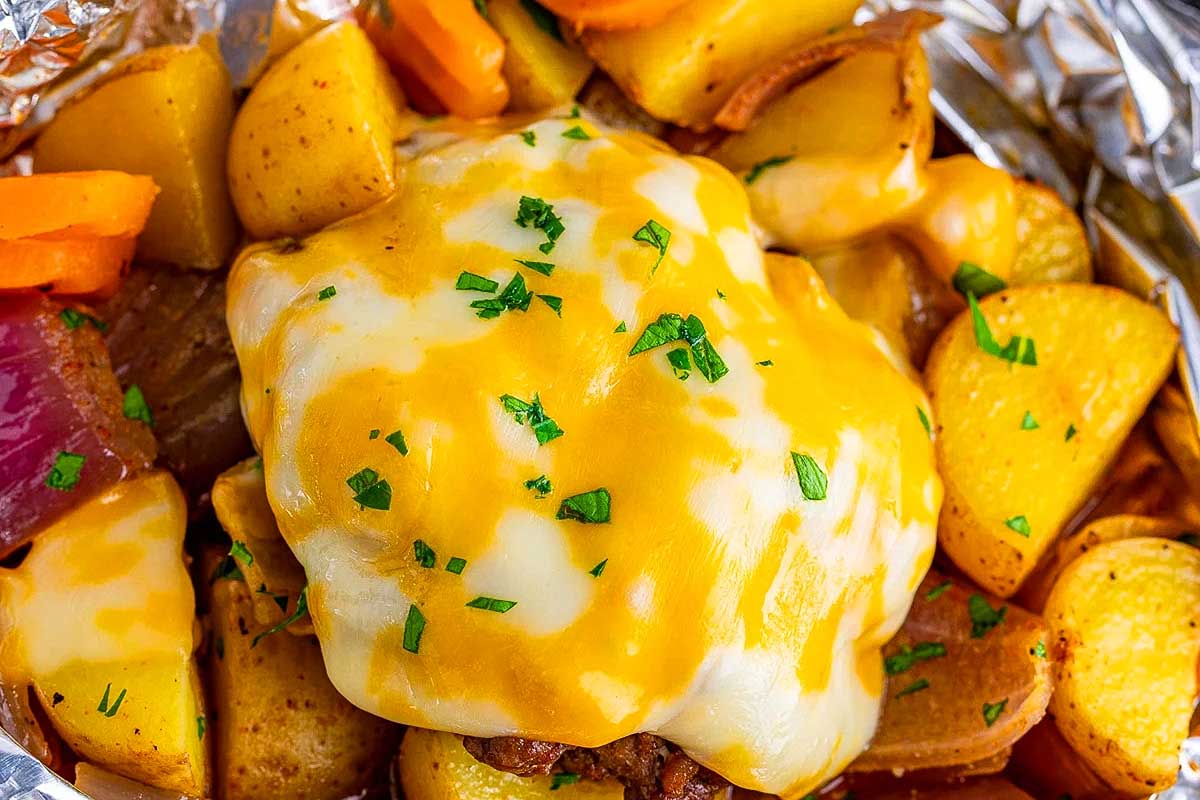 Cheesy chicken in foil with potatoes and carrots.