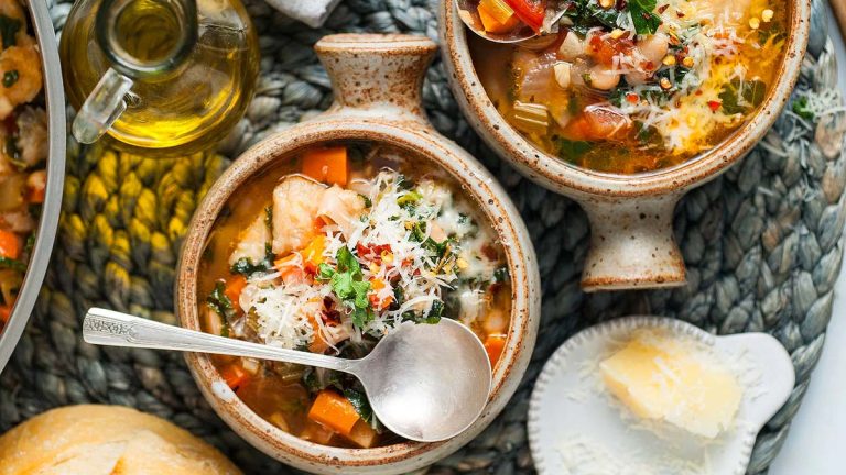 Three bowls of Italian soup on a table.
