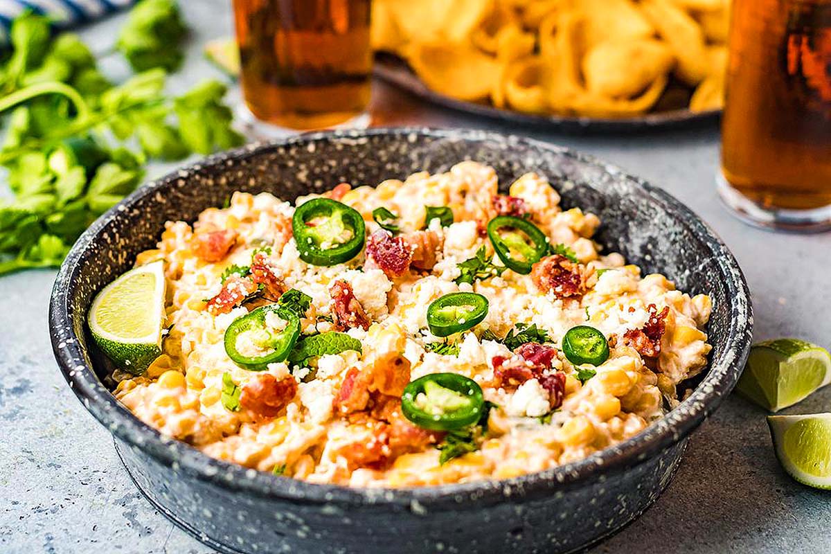 Mexican dip in a bowl with chips and salsa. This is one of the best game day dips.