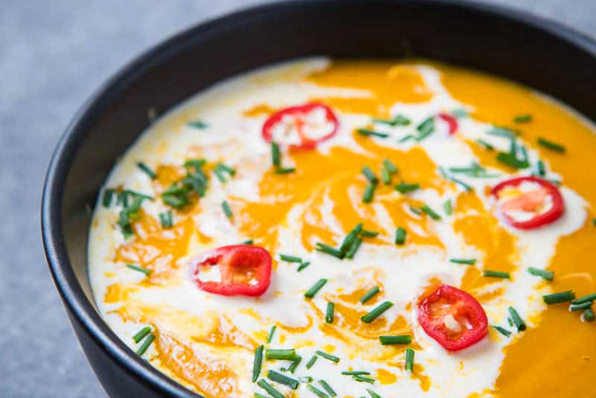 A slow cooker soup with pumpkin, cream, and peppers.