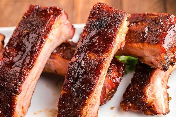 Southern Dinners That Satisfy 27 Mouthwatering BBQ ribs on a white plate, tantalizingly awaiting eager taste buds.
