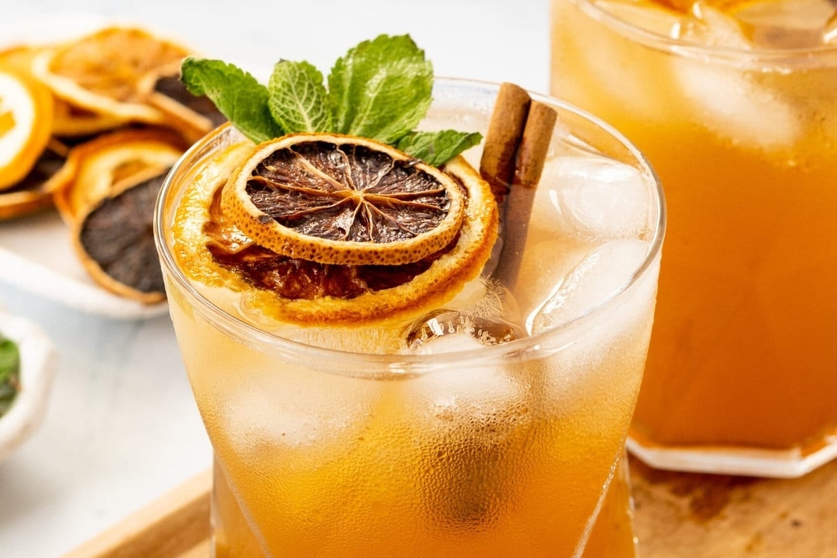 A refreshing Thanksgiving cocktail with orange slices and mint leaves.