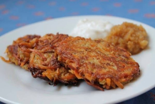 Creative Sweet Potato Recipes 11 Carrot pancakes with sour cream on a plate.
