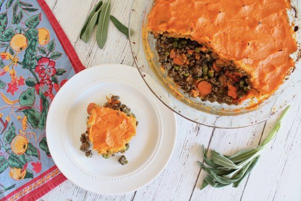 A cheap Thanksgiving potluck dish - a pie with carrots and sage on a plate.