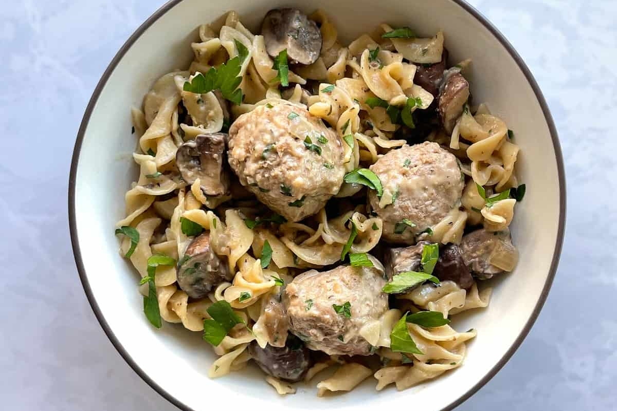 A comforting winter dinner, enjoy a bowl of pasta with meatballs and mushrooms.