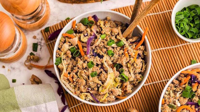 Two bowls of asian stir fry with meat and vegetables.