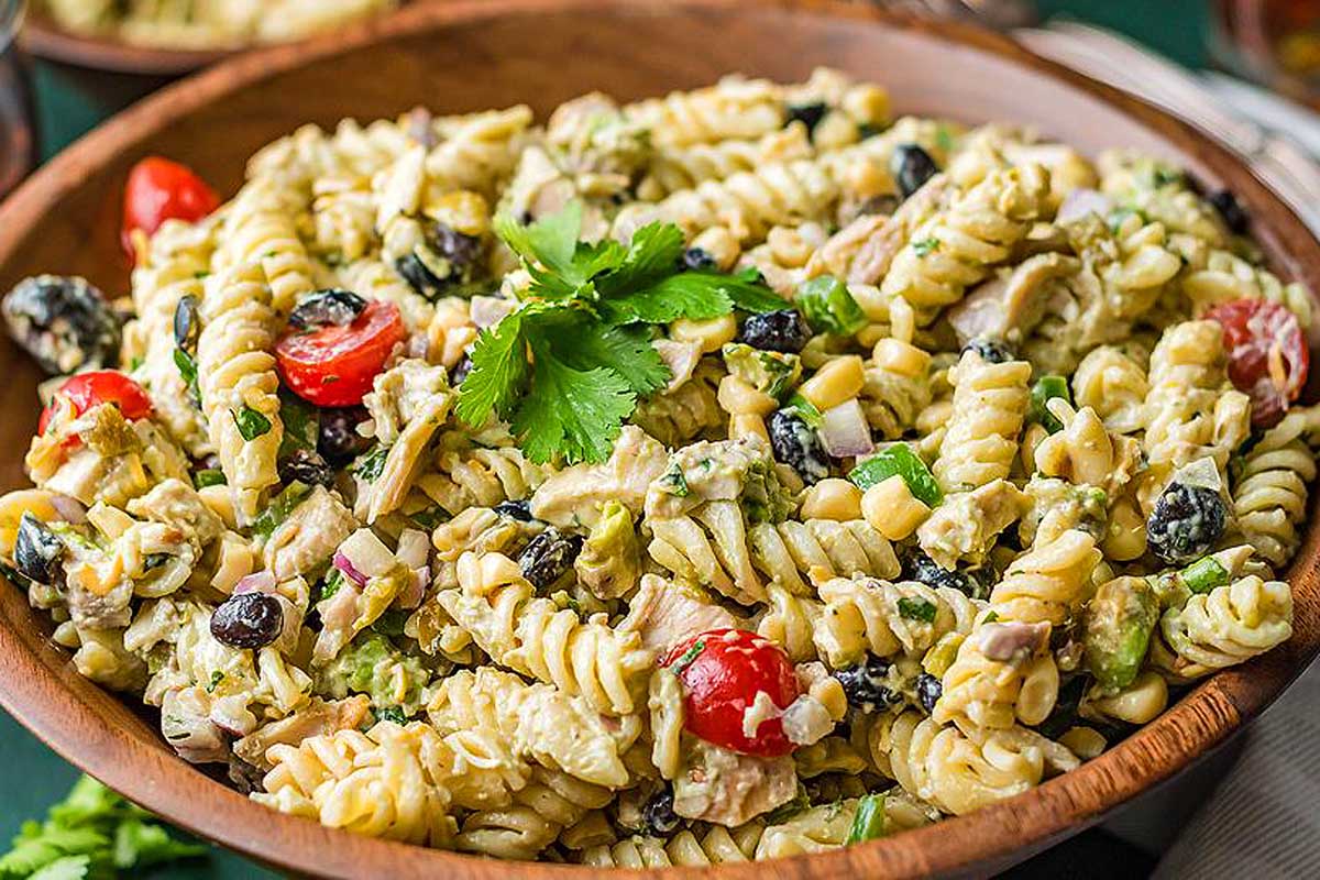 Pasta salad in a wooden bowl.