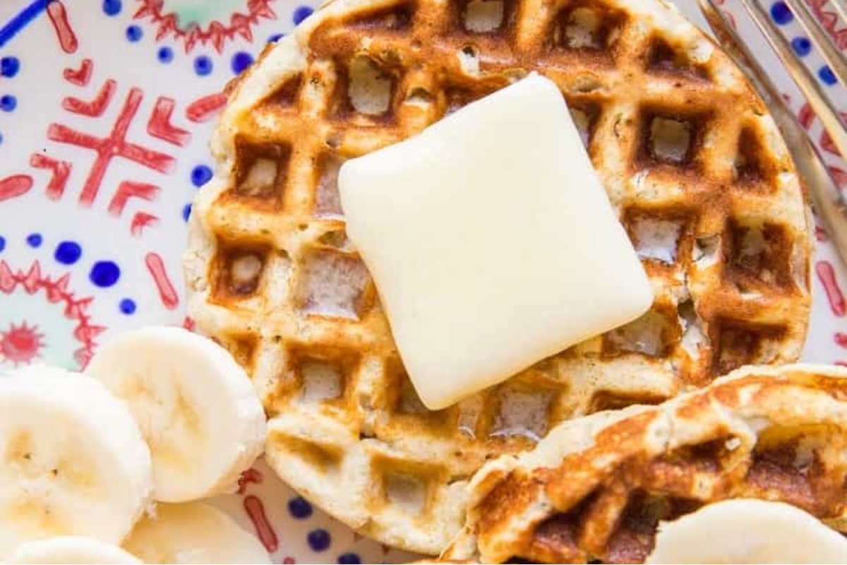 Waffle recipes with butter and bananas on a plate.