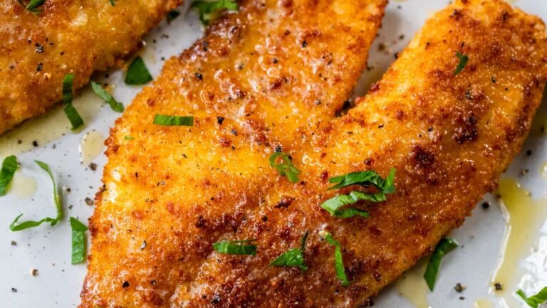 Two delicious fried fish fillets on a plate.