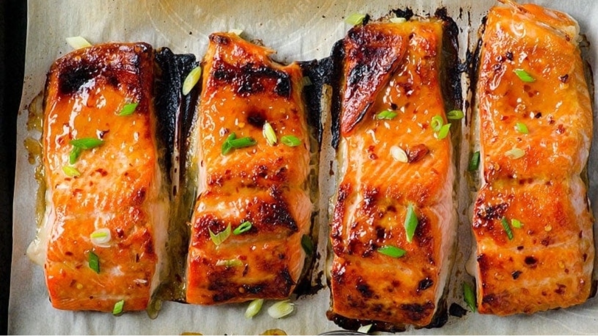 22 Salmon Dinners Your Family Will Love 14 Four salmon fillets on a baking sheet ready for dinner.