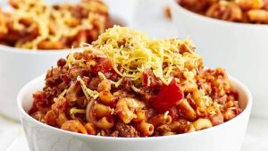 A round-up of shared soup recipes including a bowl of chili and macaroni in a white bowl.