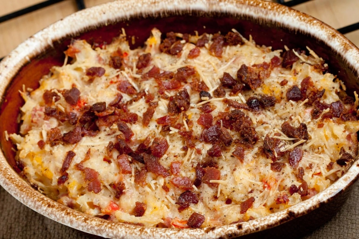 A healthy breakfast casserole dish with bacon and cheese on top, packed with high protein goodness.