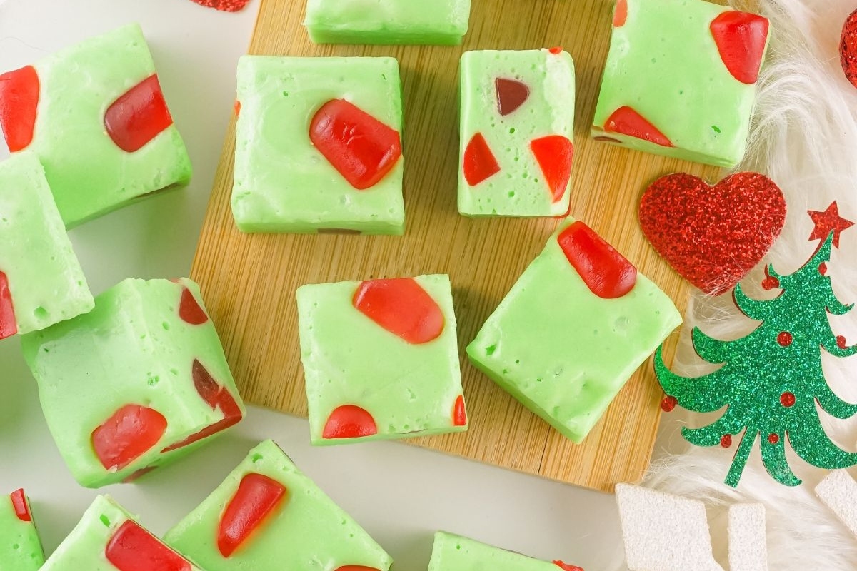 Green and red Christmas fudge, perfect for the holiday season, displayed on a cutting board.