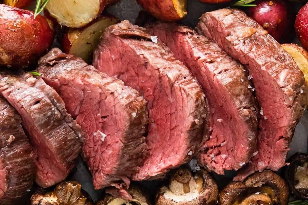 Beef dinners featuring steak, potatoes and mushrooms on a baking sheet, perfect for Christmas celebrations.