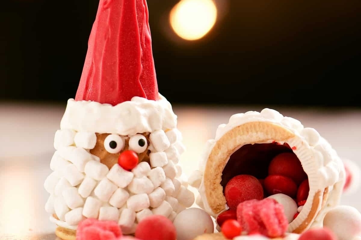 Santa-themed recipes are being prepared by a jolly Santa Claus wearing a festive hat.
