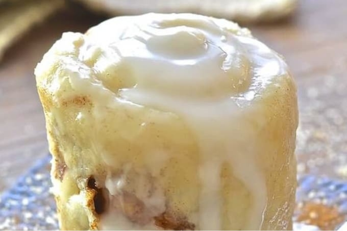 A delicious cinnamon roll with icing on top, perfect for mug cake recipes.