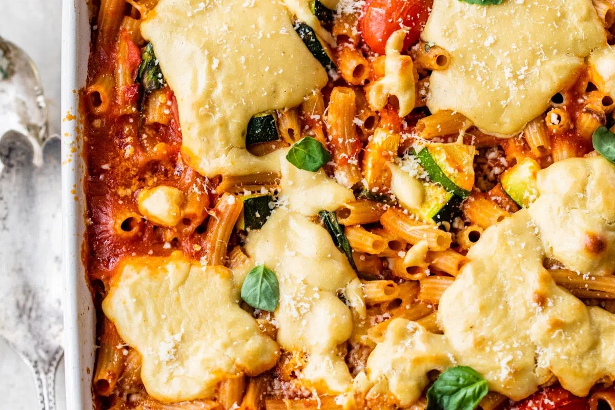 A make-ahead pasta dish filled with flavorful vegetables and melted cheese, served in a delightful baking dish.