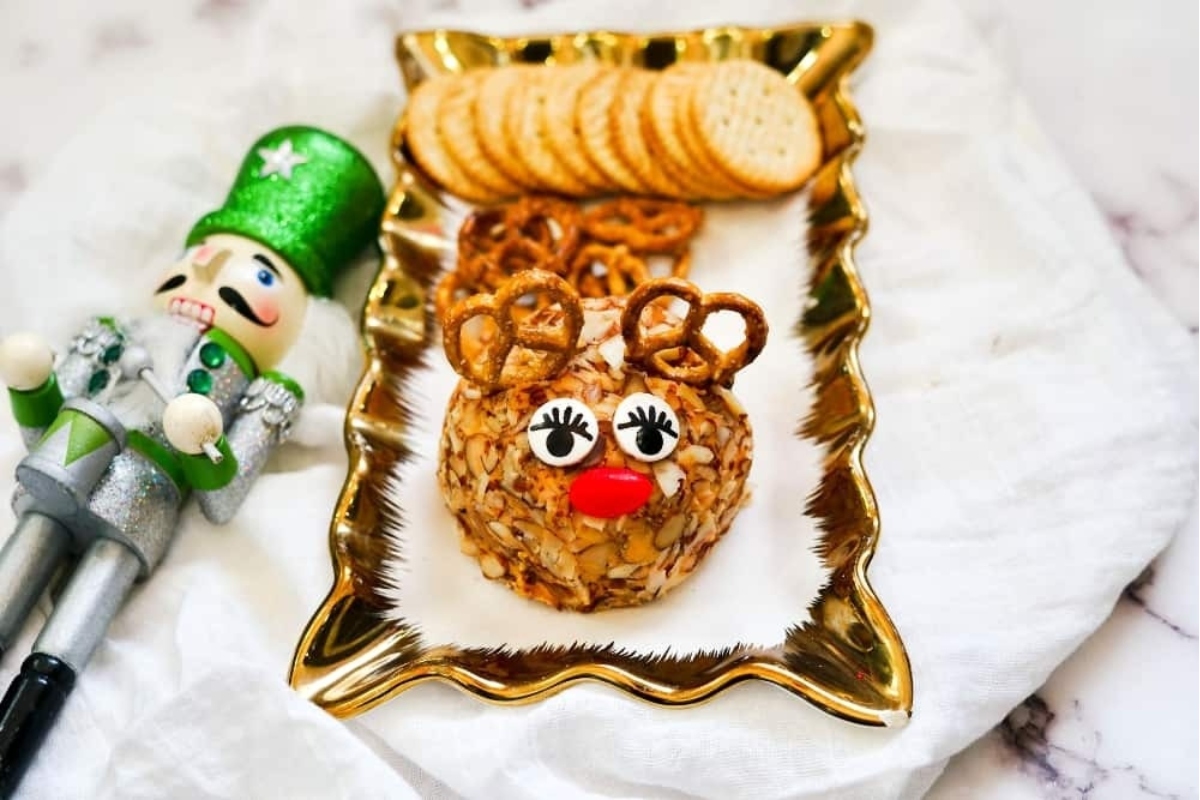 Festive cheese ball platter with crackers.