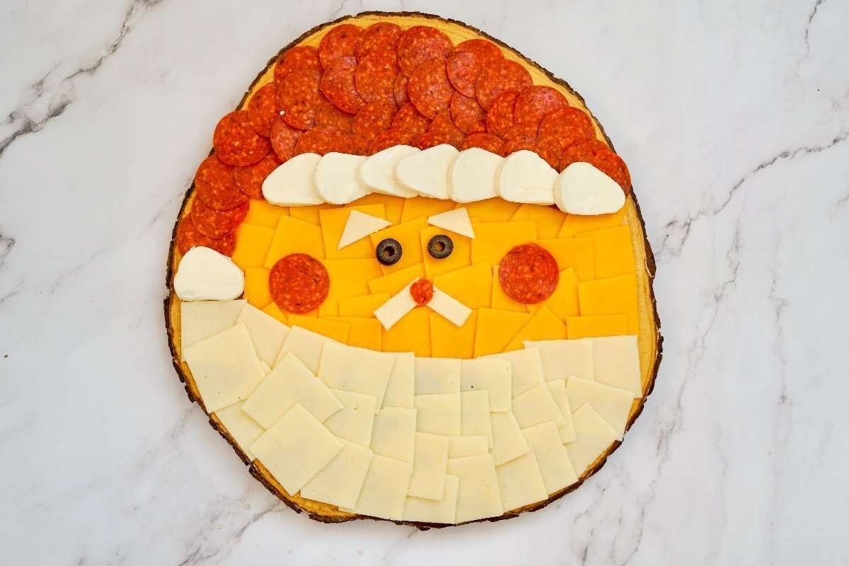 A themed pizza with a Santa face on it.