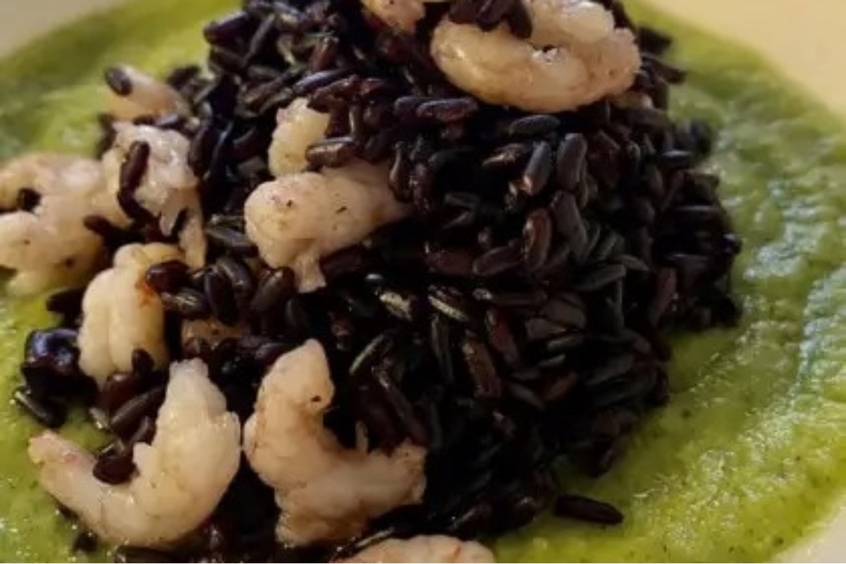 Black rice with shrimp and green sauce, perfect for a feast of the seven fishes.