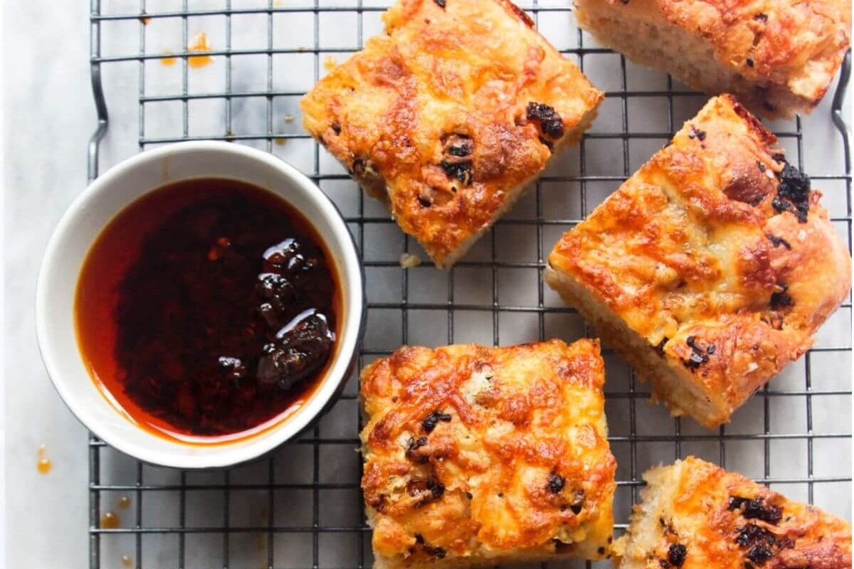 16 Easy and Delicious Focaccia Recipes to Try 9 Focaccia bread with dipping sauce on a cooling rack.