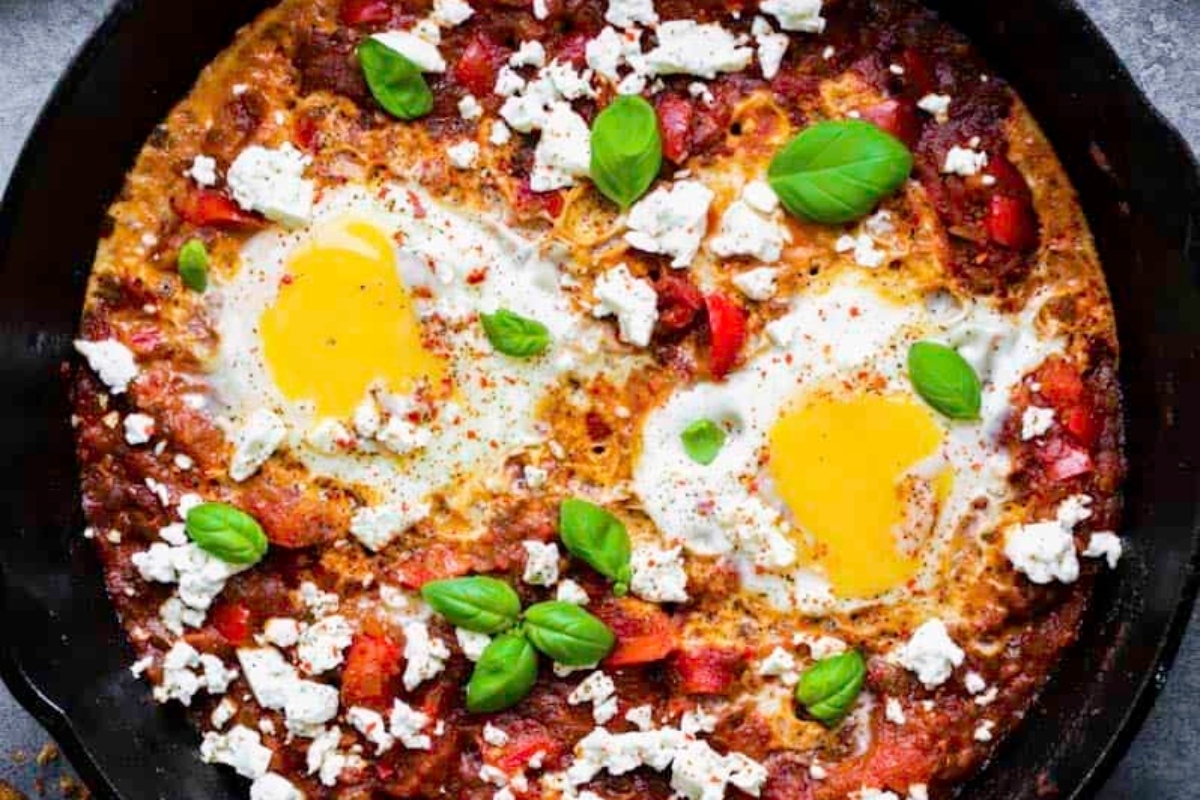 A high protein breakfast skillet with eggs, tomatoes and basil.