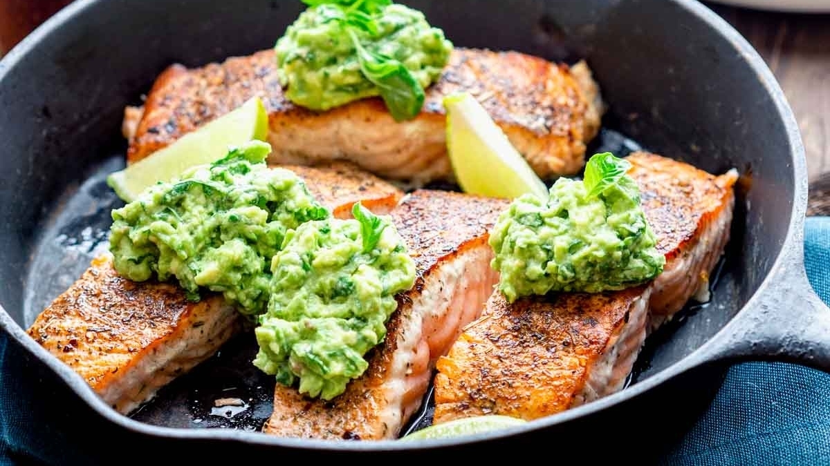22 Salmon Dinners Your Family Will Love 13 A delicious and healthy dinner option featuring tender salmon cooked to perfection in a skillet and topped with flavorful guacamole.