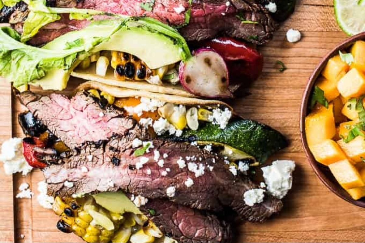 Taco Night just got better with these mouth-watering steak tacos served on a rustic wooden cutting board. Enjoy the perfect balance of flavors and textures as you savor each bite during your delicious Din