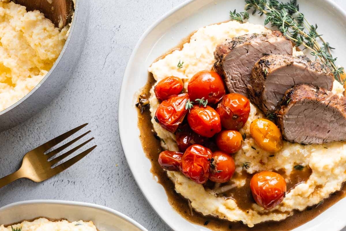 Winter dinner featuring beef tenderloin, served with creamy mashed potatoes and roasted tomatoes.