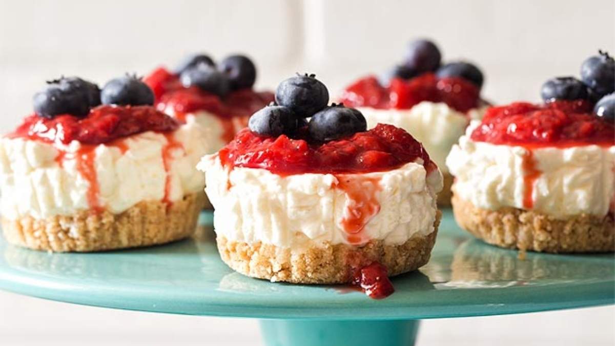 Blueberry cheesecakes presented on a blue plate.